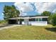 Charming single-story home featuring a stylish carport and a well-maintained front lawn under a bright, sunny sky at 5108 Tangelo Dr, New Port Richey, FL 34652