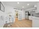 Modern kitchen featuring white cabinets, stainless steel appliances, and a stylish sliding barn door at 5108 Tangelo Dr, New Port Richey, FL 34652