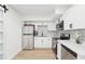 Bright kitchen features stainless steel appliances, white cabinets, and sleek countertops at 5108 Tangelo Dr, New Port Richey, FL 34652