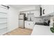 Bright kitchen features stainless steel appliances, white cabinets, and sleek countertops at 5108 Tangelo Dr, New Port Richey, FL 34652