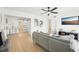 Bright living room with a gray sofa, marble-top coffee table, wood floors, and modern decor for comfortable, stylish living at 5108 Tangelo Dr, New Port Richey, FL 34652