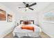 Stylishly furnished main bedroom with a window and ceiling fan at 5108 Tangelo Dr, New Port Richey, FL 34652