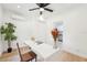 Bright office room with sleek floor, stylish decor and a peek to the kitchen at 5108 Tangelo Dr, New Port Richey, FL 34652
