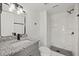 Modern bathroom with granite vanity, sleek black faucet, and a walk-in shower featuring white marbled walls and dark fixtures at 5210 S 83Rd St, Tampa, FL 33619