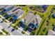 Aerial view of multiple homes in a residential area, highlighting landscaping and nearby pond at 5236 Wishing Arch Dr, Apollo Beach, FL 33572