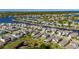Aerial view of home overlooking pond and landscaped backyard with screened in lanai in a neighborhood community at 5236 Wishing Arch Dr, Apollo Beach, FL 33572