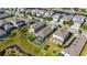 Aerial view of a neighborhood showcasing homes with well-kept yards and a waterfront community at 5236 Wishing Arch Dr, Apollo Beach, FL 33572