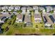 Aerial view of a home that includes a screened in patio, landscaped yard, and a pond in the backyard at 5236 Wishing Arch Dr, Apollo Beach, FL 33572