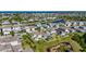 An aerial view shows the proximity of the home to a pond, featuring a landscaped yard and screened-in lanai at 5236 Wishing Arch Dr, Apollo Beach, FL 33572