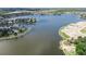 An aerial view of a waterfront community highlighting homes with access to a large lake and boat docks at 5236 Wishing Arch Dr, Apollo Beach, FL 33572