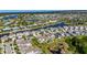 Aerial view of a waterfront community with homes along canals, offering scenic living at 5236 Wishing Arch Dr, Apollo Beach, FL 33572