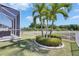 A well-maintained backyard featuring a lush lawn and decorative palm trees at 5236 Wishing Arch Dr, Apollo Beach, FL 33572