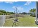 Landscaped backyard with lawn and a small tree, surrounded by a white fence at 5236 Wishing Arch Dr, Apollo Beach, FL 33572