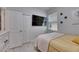 This bedroom features neutral tones, a closet and a mounted TV at 5236 Wishing Arch Dr, Apollo Beach, FL 33572