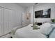 Bright bedroom featuring neutral walls, modern decor, a ceiling fan, and closet storage at 5236 Wishing Arch Dr, Apollo Beach, FL 33572