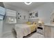Charming bedroom with a side table and neutral decor, offering a cozy retreat with ample natural light at 5236 Wishing Arch Dr, Apollo Beach, FL 33572