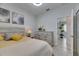 Relaxing bedroom featuring neutral tones, a comfortable bed, and a view into the hallway at 5236 Wishing Arch Dr, Apollo Beach, FL 33572