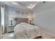 Bedroom with tray ceiling, neutral decor, and decorative art above the gray upholstered headboard at 5236 Wishing Arch Dr, Apollo Beach, FL 33572