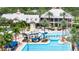 Aerial view of the community clubhouse and pool area with a slide, surrounded by palm trees at 5236 Wishing Arch Dr, Apollo Beach, FL 33572