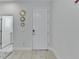 Bright entryway with modern decor and a white front door at 5236 Wishing Arch Dr, Apollo Beach, FL 33572