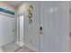 Hallway with modern decor, tile floors, and bright white walls at 5236 Wishing Arch Dr, Apollo Beach, FL 33572