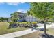 Charming home with a well-manicured lawn, vibrant landscaping, and an attached two-car garage at 5236 Wishing Arch Dr, Apollo Beach, FL 33572