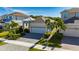 A beautifully landscaped home featuring a paved driveway and lush tropical plants at 5236 Wishing Arch Dr, Apollo Beach, FL 33572