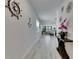 Open hallway with long view to living space, bright lighting and nautical accents at 5236 Wishing Arch Dr, Apollo Beach, FL 33572