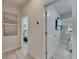 Hallway featuring neutral walls, modern artwork, and doorways to the bedroom and living spaces at 5236 Wishing Arch Dr, Apollo Beach, FL 33572