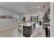 Spacious kitchen with a large island featuring pendant lighting, stainless sink, and eat-in seating at 5236 Wishing Arch Dr, Apollo Beach, FL 33572