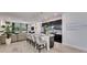 Open-concept kitchen and living area with a large island, stainless appliances, and access to outdoor patio at 5236 Wishing Arch Dr, Apollo Beach, FL 33572