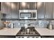 Close-up of a kitchen with stainless steel gas range and microwave; modern appliances for cooking enthusiasts at 5236 Wishing Arch Dr, Apollo Beach, FL 33572