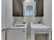 Laundry area features a washer, dryer, upper cabinets and a window at 5236 Wishing Arch Dr, Apollo Beach, FL 33572