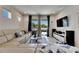 Bright living room featuring a comfortable sectional sofa and sliding glass doors to the outdoor patio at 5236 Wishing Arch Dr, Apollo Beach, FL 33572