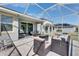 Well appointed covered patio with seating and a grill overlooking the yard at 5236 Wishing Arch Dr, Apollo Beach, FL 33572