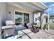 Outdoor grill and lounge area next to a covered patio with outdoor seating at 5236 Wishing Arch Dr, Apollo Beach, FL 33572