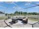 Outdoor living space with wicker furniture, a grill, and a lake view at 5236 Wishing Arch Dr, Apollo Beach, FL 33572