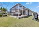 A spacious screened patio featuring comfortable seating and a grill, perfect for outdoor entertaining at 5236 Wishing Arch Dr, Apollo Beach, FL 33572