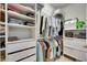 Walk-in closet boasts custom shelves and hanging racks, maximizing storage and organization at 5236 Wishing Arch Dr, Apollo Beach, FL 33572