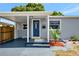 Inviting front entrance with a blue door and covered porch at 5340 4Th S Ave, St Petersburg, FL 33707