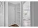 Hallway featuring convenient storage and a view of a well-lit bedroom at 5340 4Th S Ave, St Petersburg, FL 33707