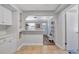 Open view to kitchen with white cabinets, light countertops and tile flooring at 5340 4Th S Ave, St Petersburg, FL 33707
