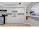 Kitchen showcases white cabinets, light countertops and tile flooring at 5340 4Th S Ave, St Petersburg, FL 33707