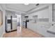 Bright kitchen featuring stainless steel appliances and white cabinetry at 5340 4Th S Ave, St Petersburg, FL 33707