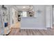 View into living room from kitchen showing hardwood floors and open floorplan at 5340 4Th S Ave, St Petersburg, FL 33707