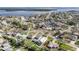 Aerial view showcasing homes in a waterfront neighborhood with lush greenery, waterways, and scenic bay views at 5426 Venetian Ne Blvd, St Petersburg, FL 33703