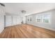 Large bedroom with wood floors, overhead lighting and two windows with white blinds at 5426 Venetian Ne Blvd, St Petersburg, FL 33703