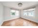 Sun-filled bedroom with hardwood floors, neutral walls, and large windows dressed with sleek roller shades at 5426 Venetian Ne Blvd, St Petersburg, FL 33703