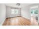 This bedroom features hardwood flooring, a ceiling light, and windows with blinds at 5426 Venetian Ne Blvd, St Petersburg, FL 33703