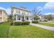 Charming two-story home with a beautifully landscaped front yard and a decorative water fountain at 5426 Venetian Ne Blvd, St Petersburg, FL 33703